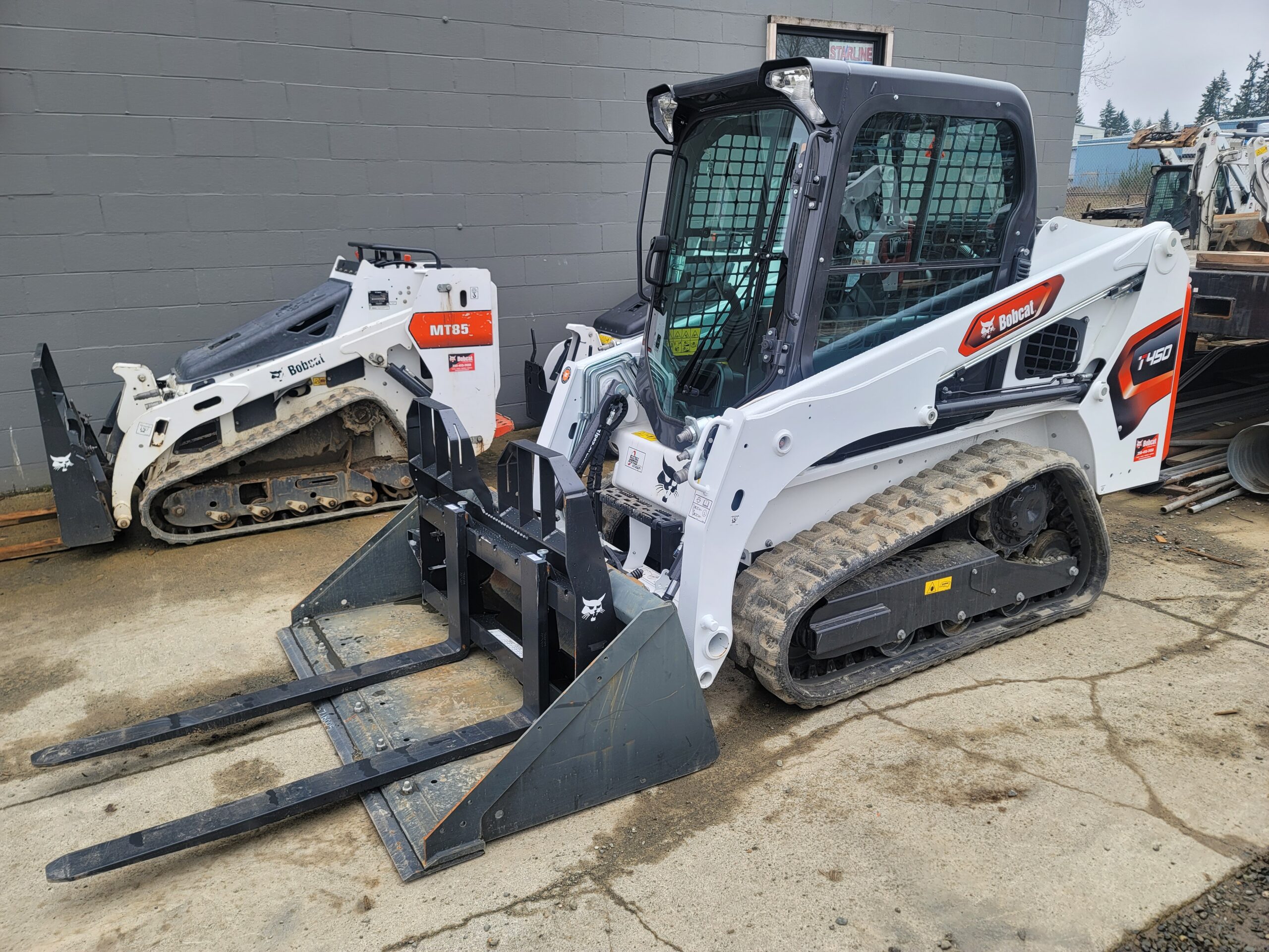 Side view of T450 with bucket and forks