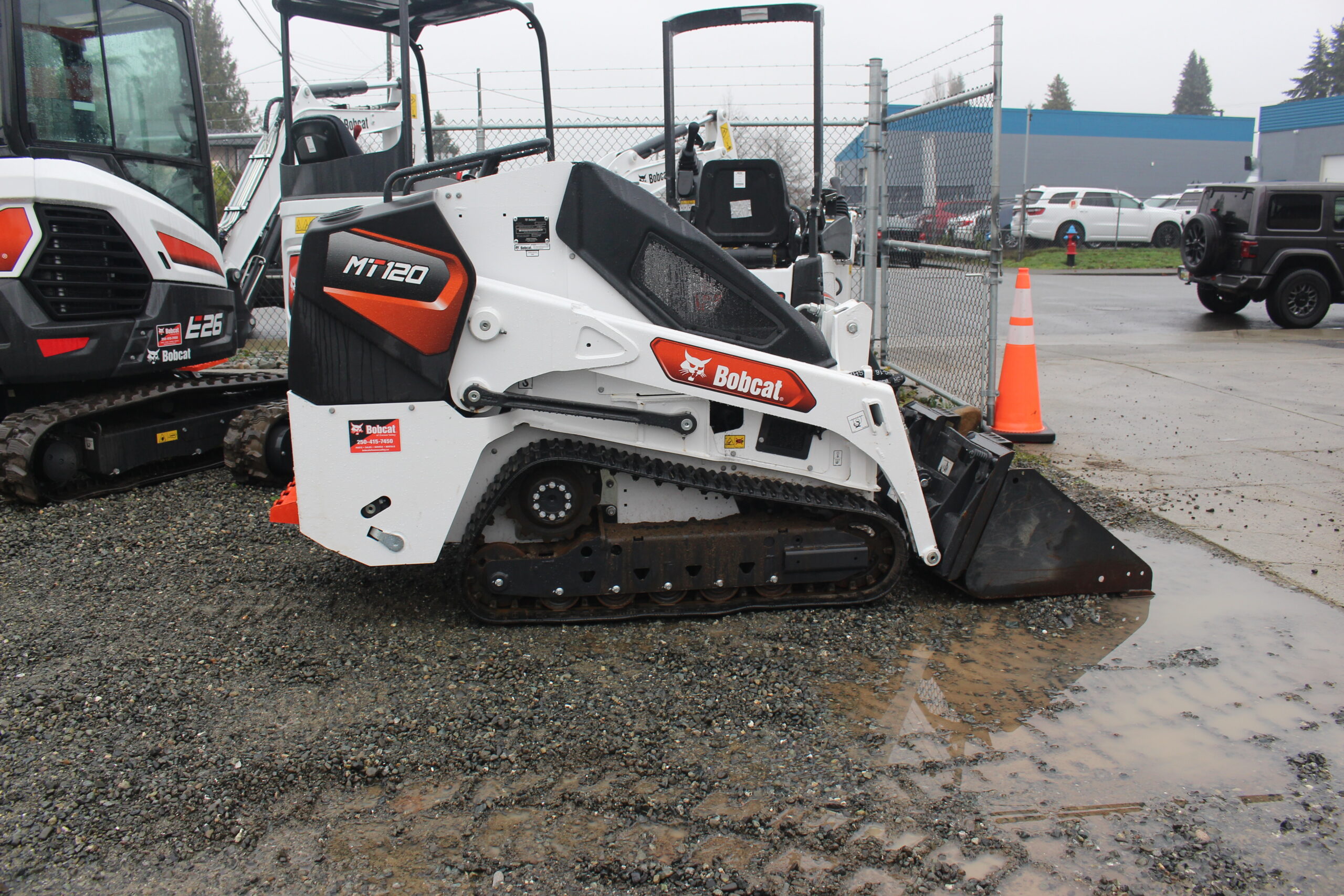 Side view of mini track loader with bucket